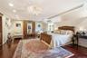 Expansive primary bedroom, featuring two custom outfitted closets, cherrywood flooring.