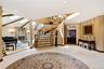 Grand entry with marble flooring, and curved staircase.