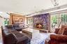 Stone-clad fireplace, wood-finish flooring, and French doors