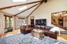 Vaulted ceiling with exposed wood beams and skylights