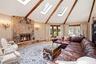 Vaulted ceiling with exposed wood beams,  skylights, recessed lighting, and hardwood flooring