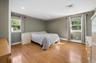 Spacious primary bedroom with ample closets, hardwood floors, recessed lighting and en-suite bath.