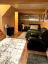 Wood-finish flooring throughout, recessed ceiling lighting, and built-in shelving