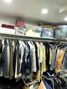 Recessed ceiling lighting illuminating a built-in closet system featuring upper shelving and multiple clothing rods