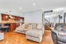 Hardwood flooring, recessed lighting, crown molding, stainless steel appliances, and a tiled kitchen backsplash