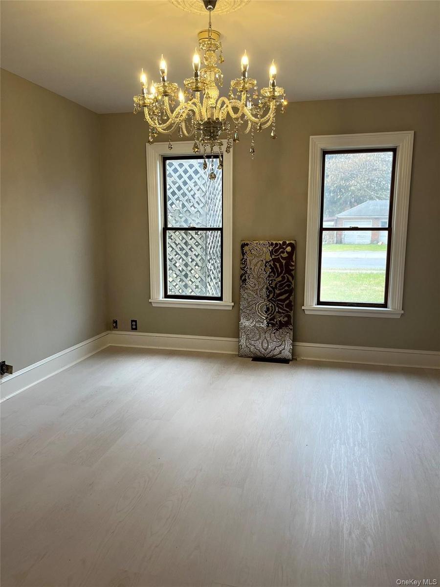 Light wood-finish flooring with crisp white baseboards