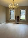 Light wood-finish flooring with crisp white baseboards