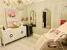 Chandelier lighting, decorative wall mirrors, built-in wall paneling, and wood-finish flooring