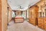 Carpeted flooring, ceiling fan, and multiple windows