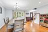 Hardwood flooring throughout, bay window, decorative chandelier, recessed lighting, and a stained wood entry door with oval glass insert