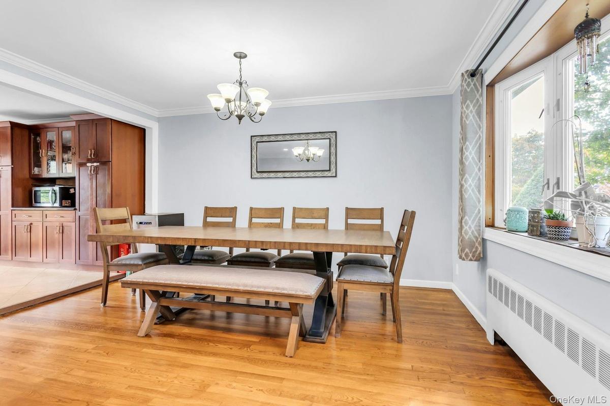 Wood-finish flooring with crown molding and a multi-pane window