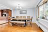 Wood-finish flooring with crown molding and a multi-pane window