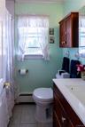 Bathroom featuring a vanity with an integrated sink, a wall-mounted cabinet, and tiled flooring