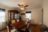 Wood-finish flooring, crown molding, ceiling fan, and window with blinds