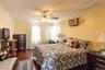 Crown molding detail, wood-finish flooring, ceiling fan, and wall-mounted air conditioning unit