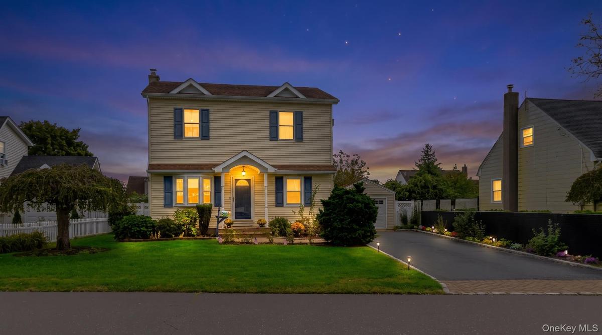 Two-story residence featuring siding exterior, an arched entry, and blue window shutters
