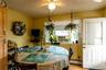 Recessed window with an air conditioning unit, ceiling fan with integrated lighting, wood-finish flooring, and a paneled door with a glass insert