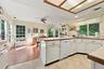 The Wonderful Large Open Eat In Kitchen & Leisure Room Is Wrapped With Walls Of Cabinetry & Illuminated With Natural Light.