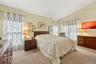 The Warm & Inviting, Well Sized Primary Bedroom Offers Beautiful Vaulted/Volume Ceilings, Upgraded Carpeting, Large Tri State Windows For Natural Ligh