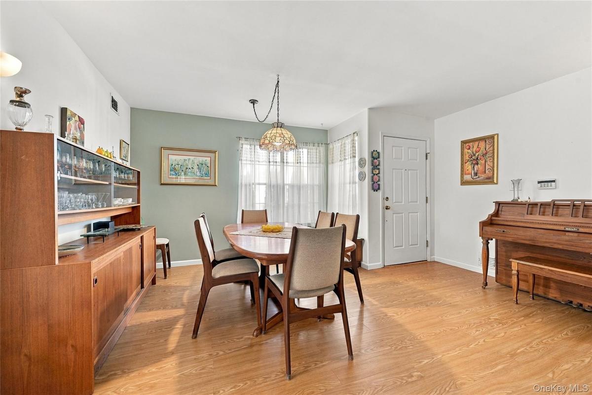 The Formal Entrance Foyer Opens Into A Beautiful Open Formal Dining Room & Formal Living Room...The Spacious Formal Dining Room Offers  Large Corner W
