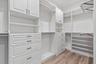 Primary Bedroom Walk in Closet with built ins