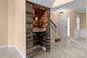 Wood accents, a decorative ceiling, and pendant lighting make this custom wine nook a conversation piece.