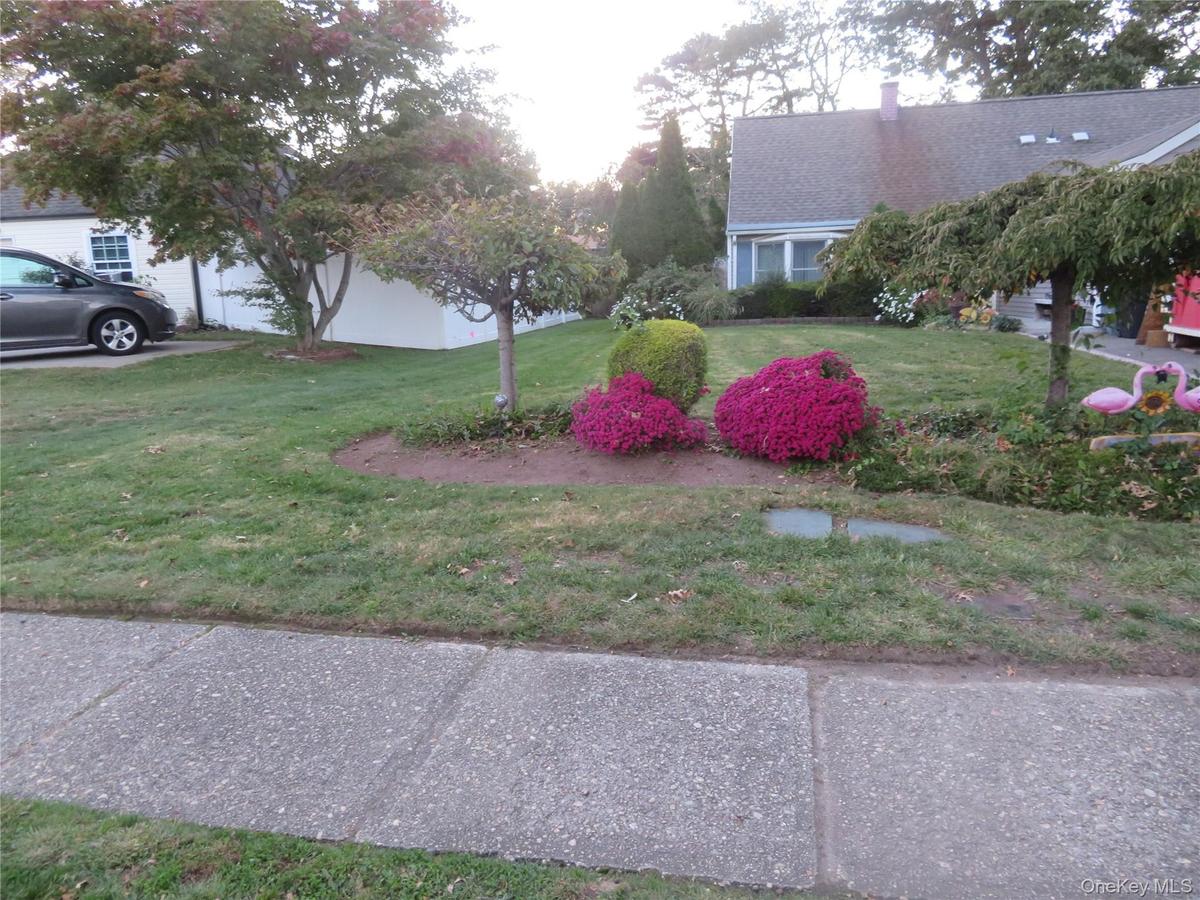 Manicured lawn with mature trees and vibrant landscaping