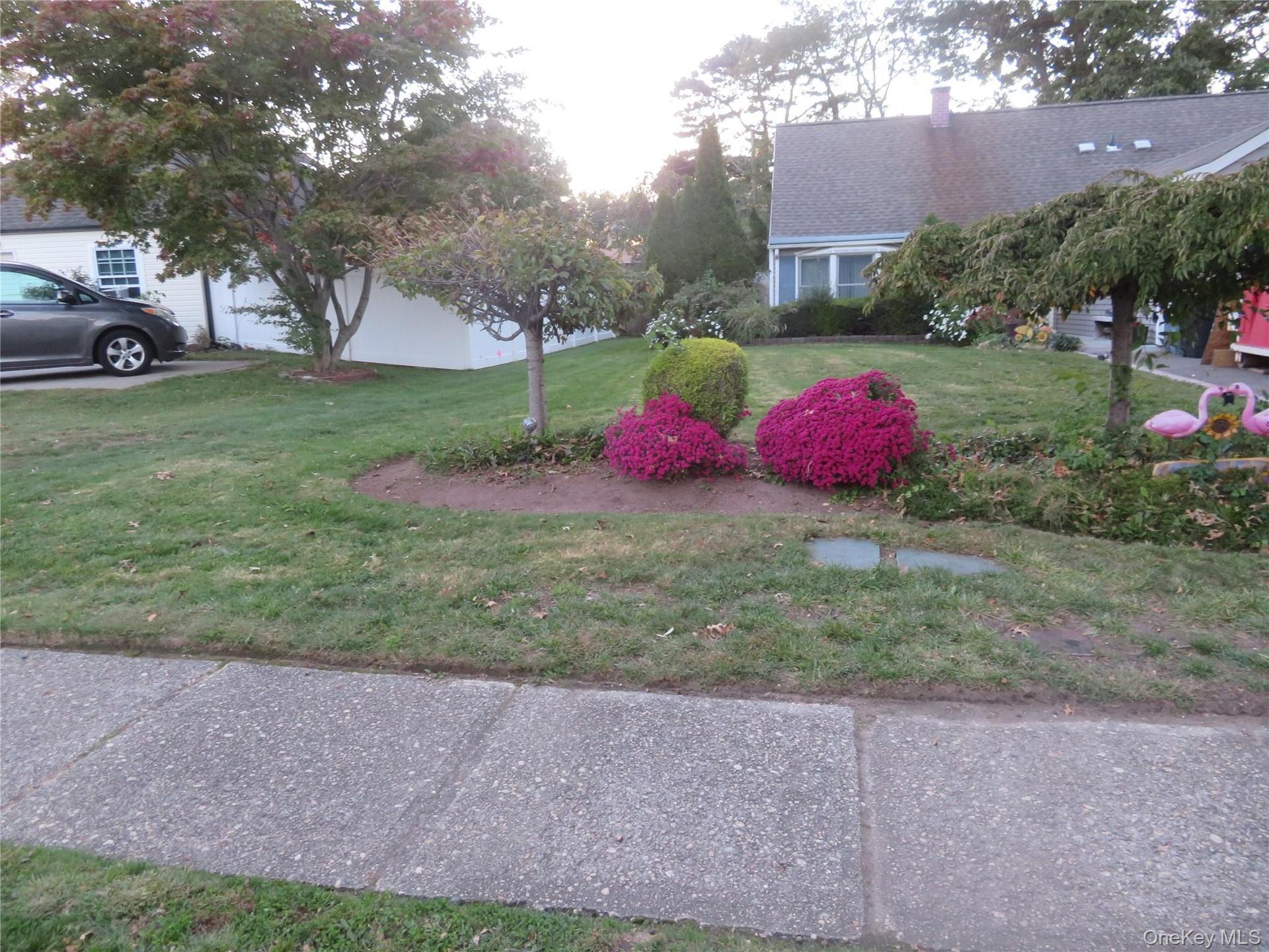 Manicured lawn with mature trees and vibrant landscaping