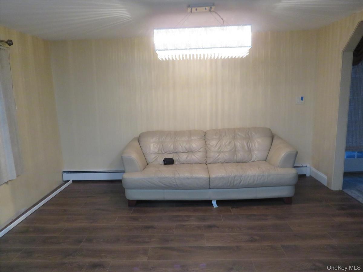 Wood-finish flooring with a modern linear ceiling fixture