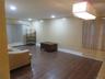 Recessed ceiling lighting, wood-finish flooring, and a decorative chandelier