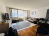 Living room featuring a textured ceiling and a wall unit AC