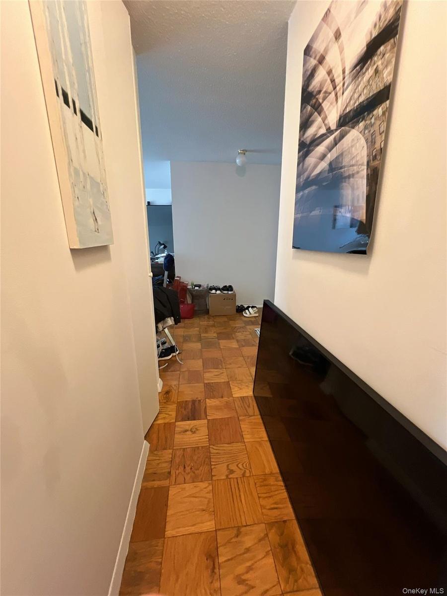 Hall featuring a textured ceiling