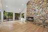 Sliding doors open to the deck overlooking the private wooded grounds.