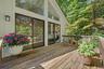 A private oasis off the primary bedroom, perfect for morning coffee amid peaceful wooded surroundings.