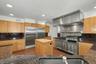 Professional Garland range with griddle, salamander, and double ovens, complemented by Sub Zero refrigeration.