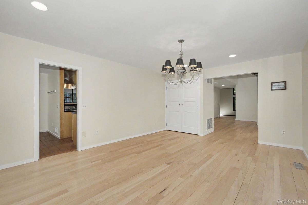 Light-filled formal dining room with a large picture window and direct access to the kitchen, ideal for entertaining.