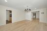 Light-filled formal dining room with a large picture window and direct access to the kitchen, ideal for entertaining.