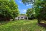 Large backyard with mature specimen plantings