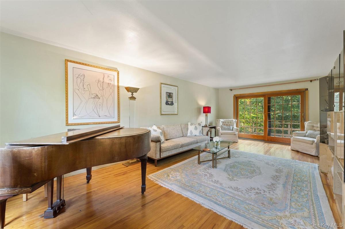 Hardwood flooring throughout with glass sliding doors to deck.