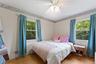 Hardwood flooring, dual windows and ceiling fan.