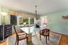 Hardwood flooring, broad window with valance, and a ceiling light fixture.