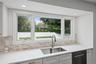 Large picture window overlooks the yard.