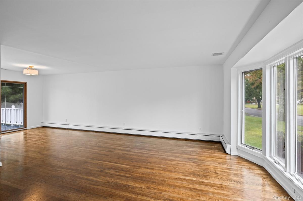 Light and Bright large Bow Window. Beautiful Hardwood Flooring