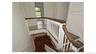 Hardwood stairs with white balusters and dark wood handrails