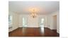 Hardwood flooring, dual pane windows, classic chandelier, crown molding, and white trim