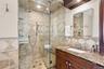 A luxurious steam shower featuring eight shower heads, custom controls, and elegant finishes for a true spa-like experience.