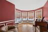 Turret music room with curved wall of windows and built-in window seat