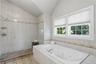 Jacuzzi tub, glass-enclosed shower, and double vanity