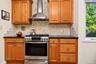 5 burner stove and tumble marble backsplash
