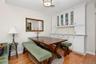 Dining room has hardwood floors and built in wall unit with marble top